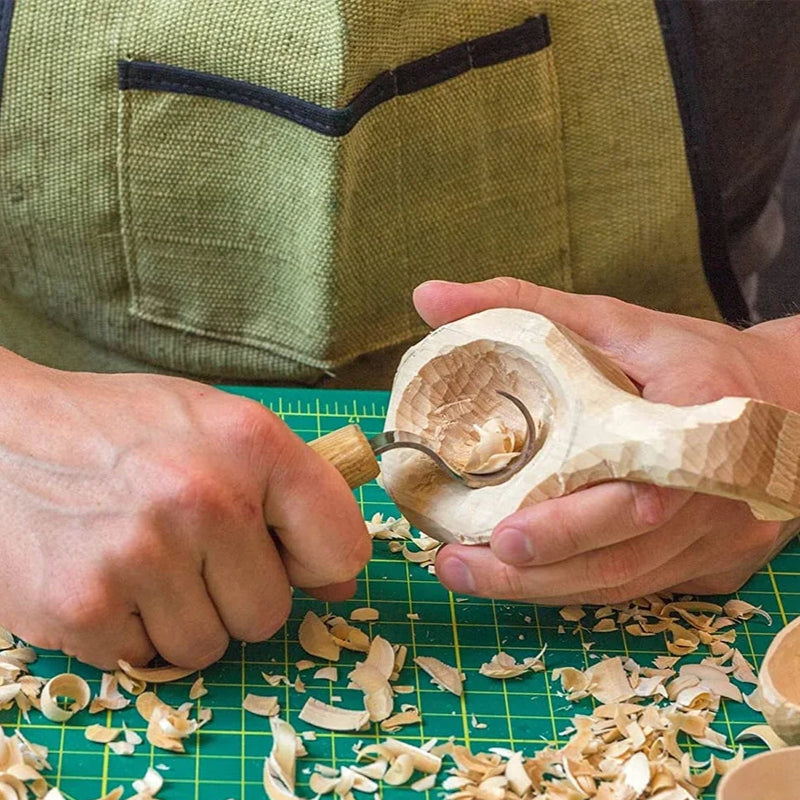 hand carving a wooden spoon with curved sppon blade knife